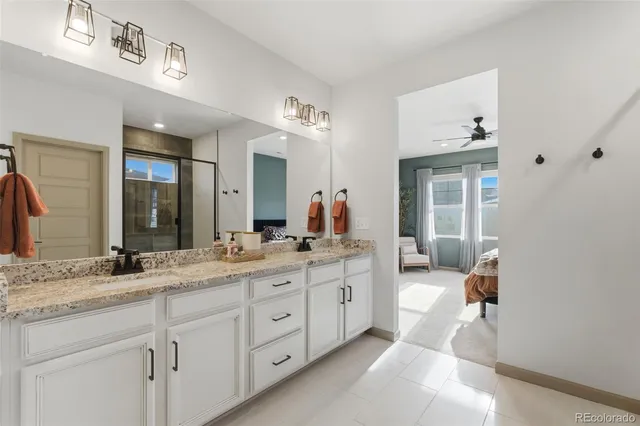 a bathroom with a granite countertop sink mirror and toilet