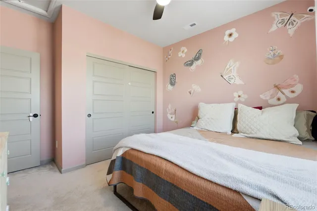 a bedroom with a bed and a painting on the wall