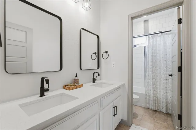a bathroom with a double vanity sink mirror and