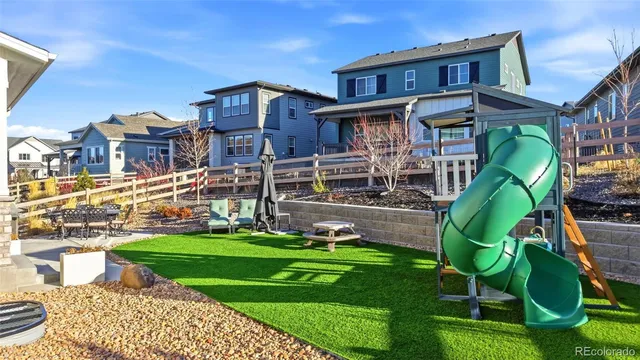 a view of a city with a big yard plants and large trees
