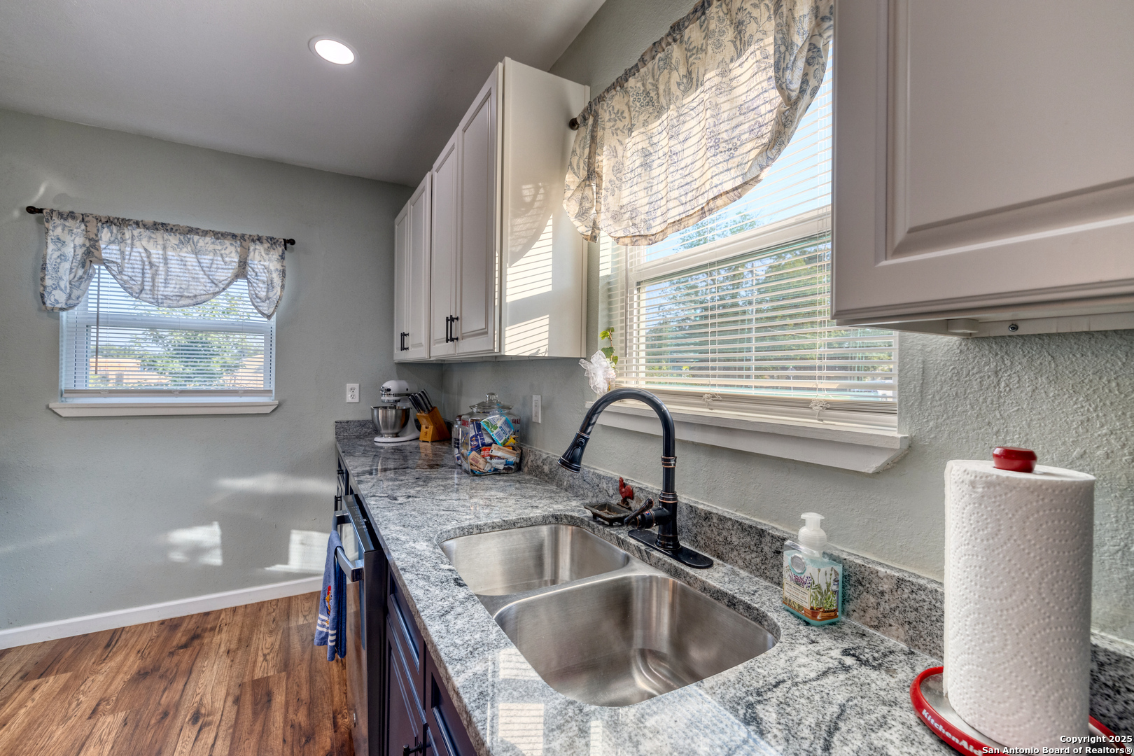 1100 North High Street Uvalde, TX 78801 - Photo 11 of 40 a kitchen with a sink a window and cabinets