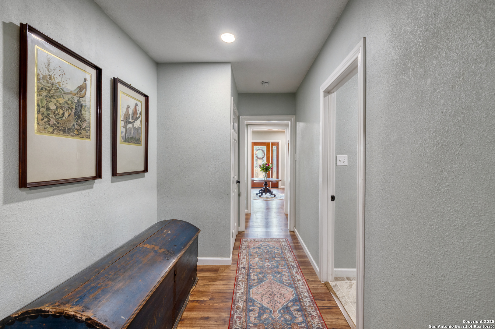 1100 North High Street Uvalde, TX 78801 - Photo 18 of 40 a hallway with front door wooden floor and windows
