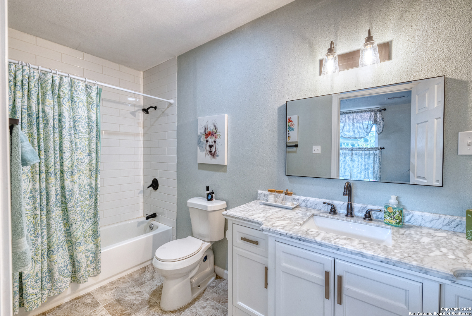 1100 North High Street Uvalde, TX 78801 - Photo 21 of 40 a bathroom with a granite countertop sink toilet and shower