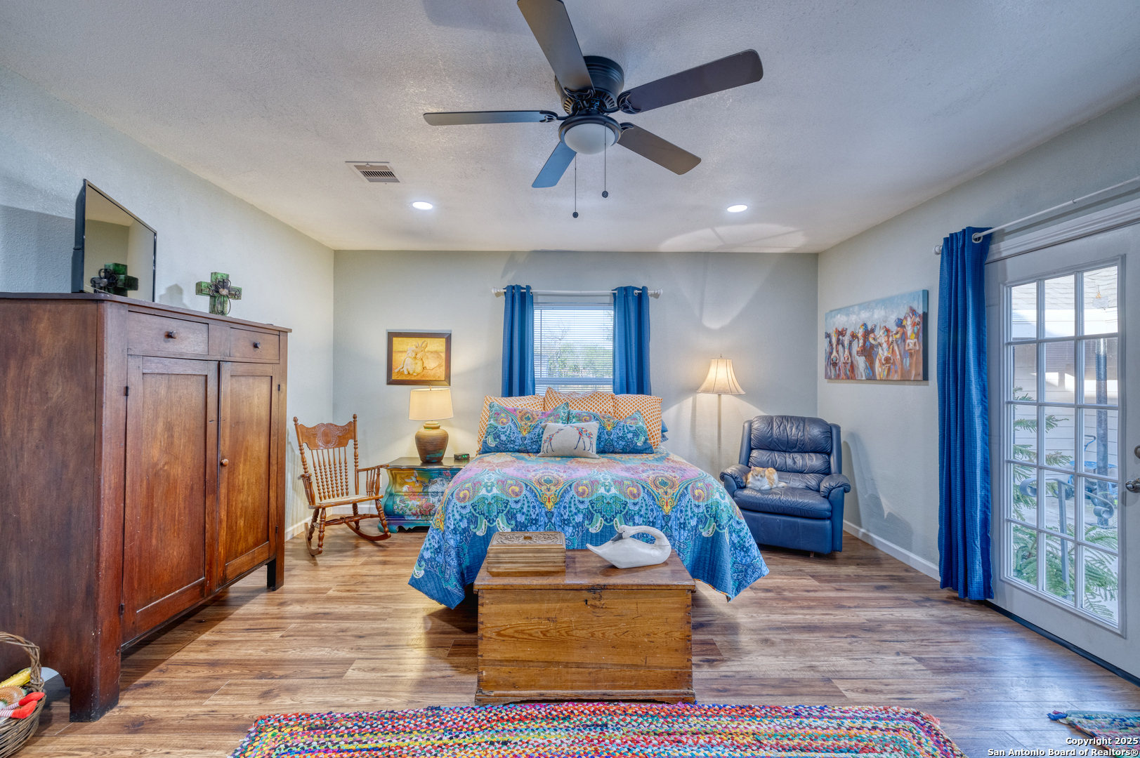 1100 North High Street Uvalde, TX 78801 - Photo 23 of 40 a bedroom with furniture window and wooden floor