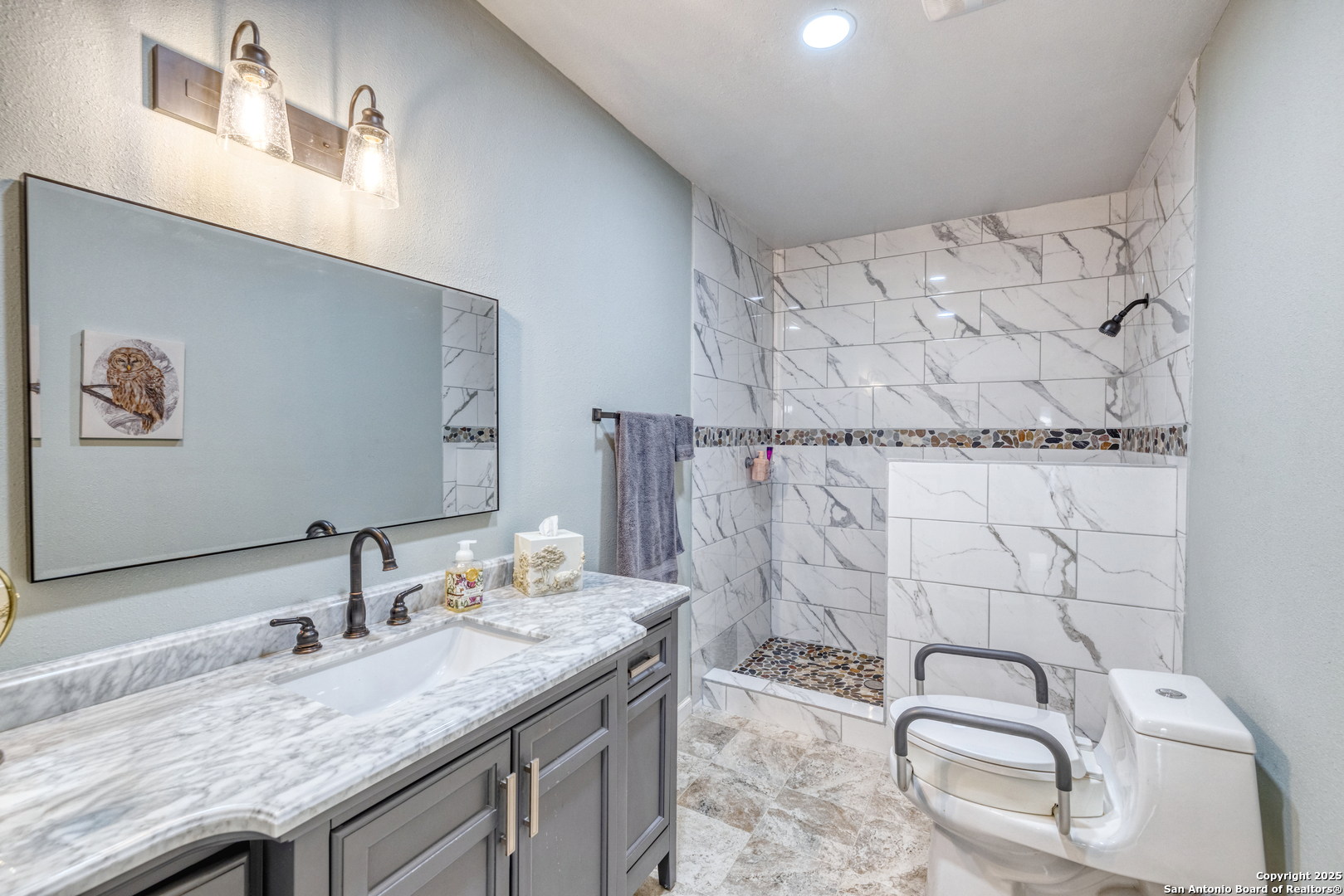 1100 North High Street Uvalde, TX 78801 - Photo 24 of 40 a bathroom with a granite countertop sink and a mirror