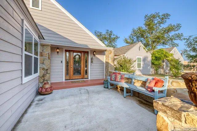 a backyard of a house with table and chairs