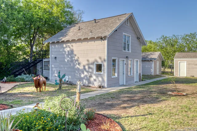 a living room with furniture and a book shelf