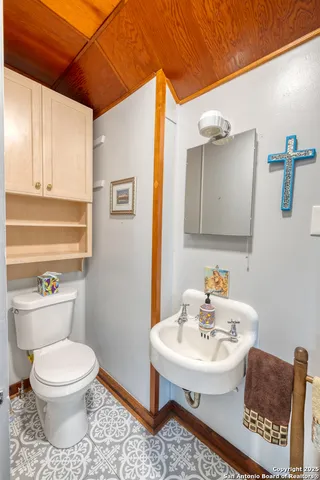 a view of a balcony with wooden floor and outdoor seating