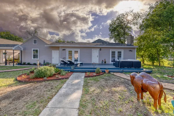 a bed sitting in a spacious bedroom next to a window