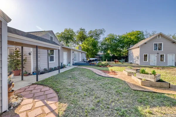 a view of backyard with swimming pool and outdoor seating