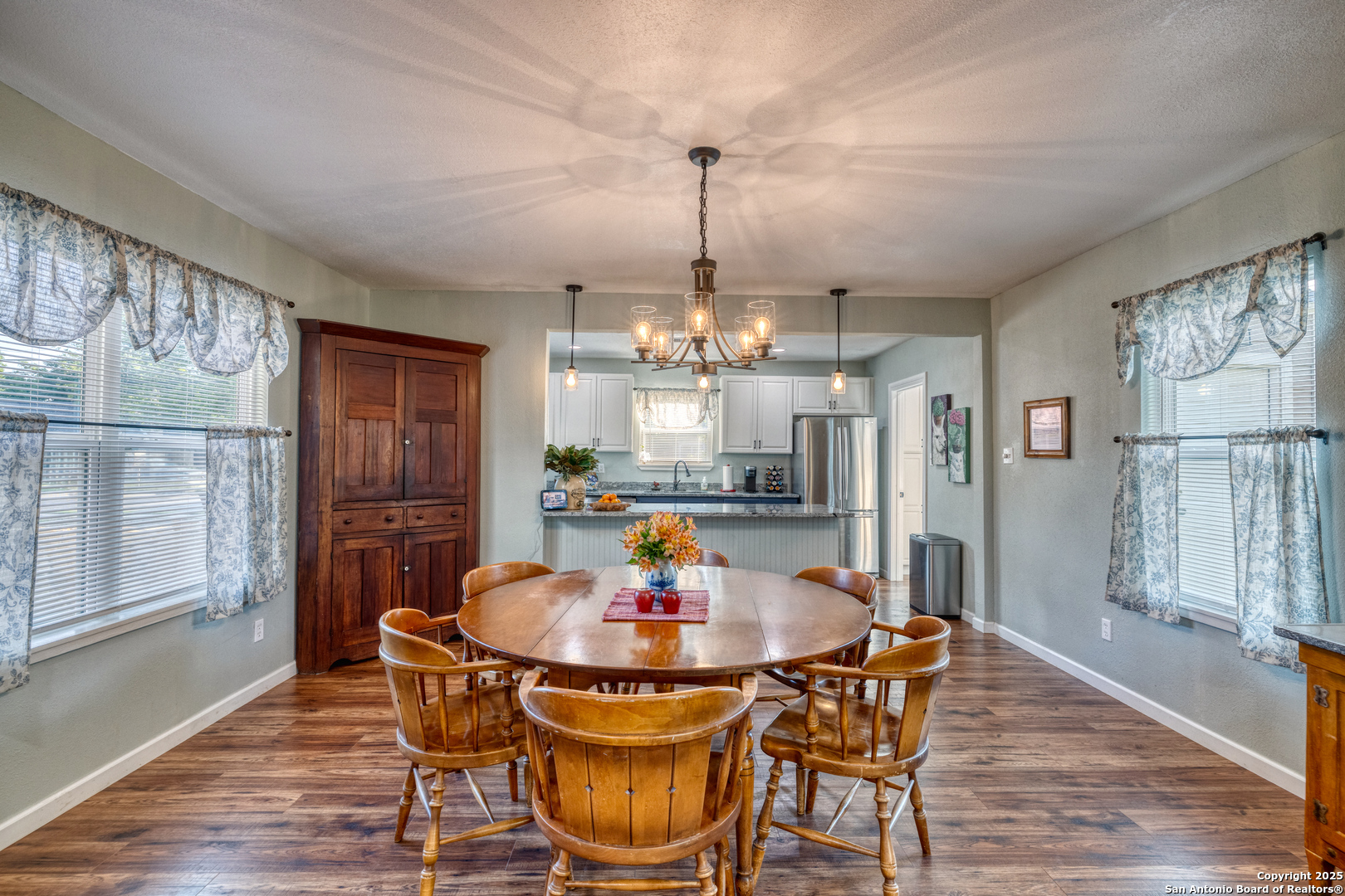 1100 North High Street Uvalde, TX 78801 - Photo 8 of 40 a kitchen with stainless steel appliances a dining table chairs and chandelier