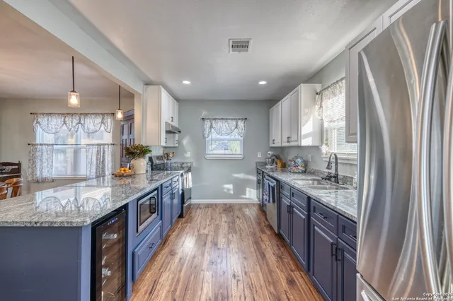a large kitchen with stainless steel appliances granite countertop lots of counter top space