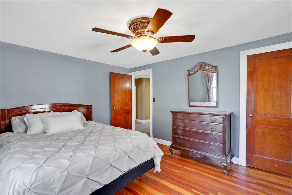 48 Oregon Street Springfield, MA 01118 - Photo 11 of 31 a bedroom with a bed and a chandelier