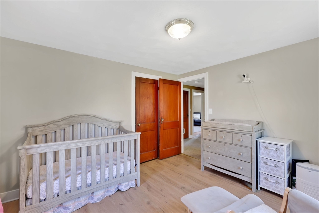 48 Oregon Street Springfield, MA 01118 - Photo 14 of 31 a bedroom with furniture and baby crib