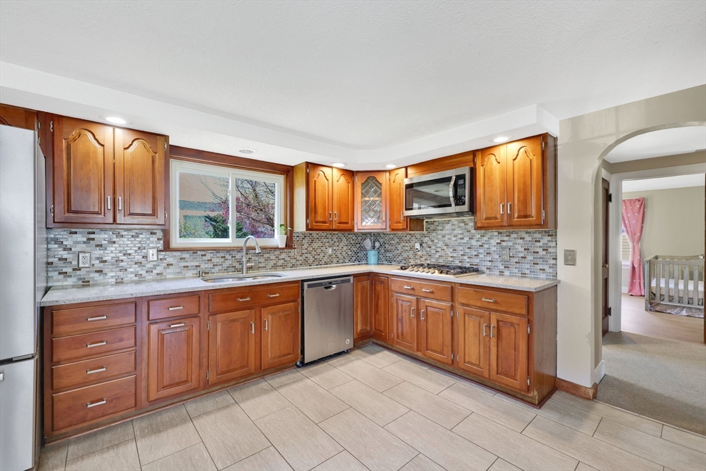 48 Oregon Street Springfield, MA 01118 - Photo 17 of 31 a kitchen with stainless steel appliances granite countertop a sink and cabinets