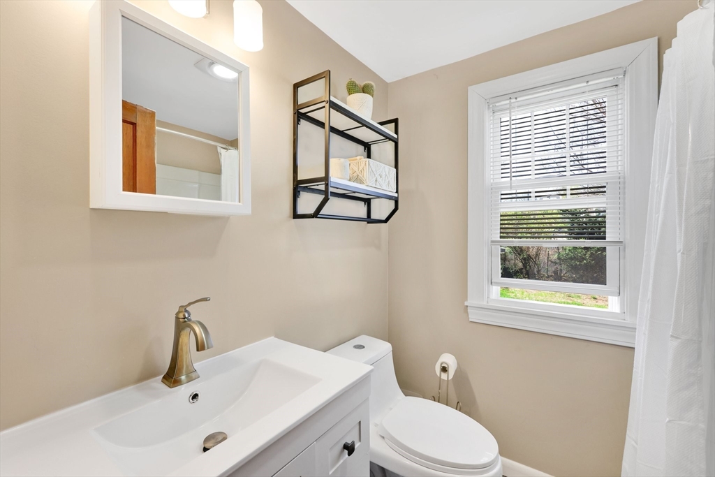 48 Oregon Street Springfield, MA 01118 - Photo 8 of 31 a bathroom with a toilet sink and mirror