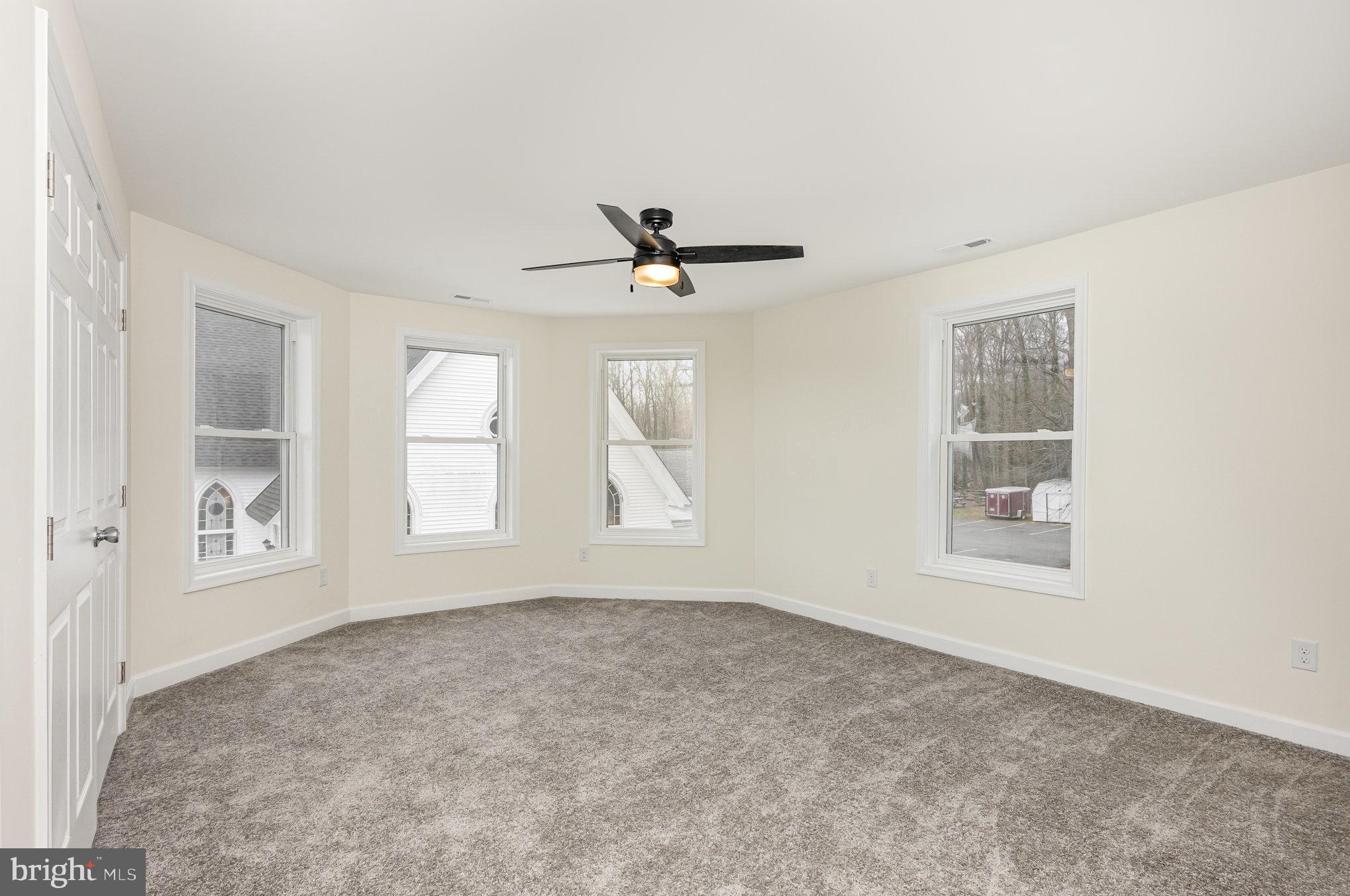 1591 Blue Ball Road Elkton, MD 21921 - Photo 11 of 30 an empty room with windows and ceiling fan