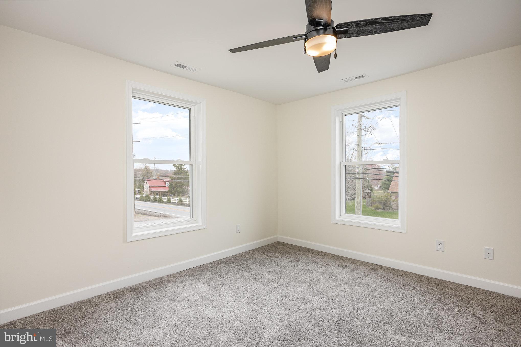 1591 Blue Ball Road Elkton, MD 21921 - Photo 13 of 30 an empty room with windows and fan