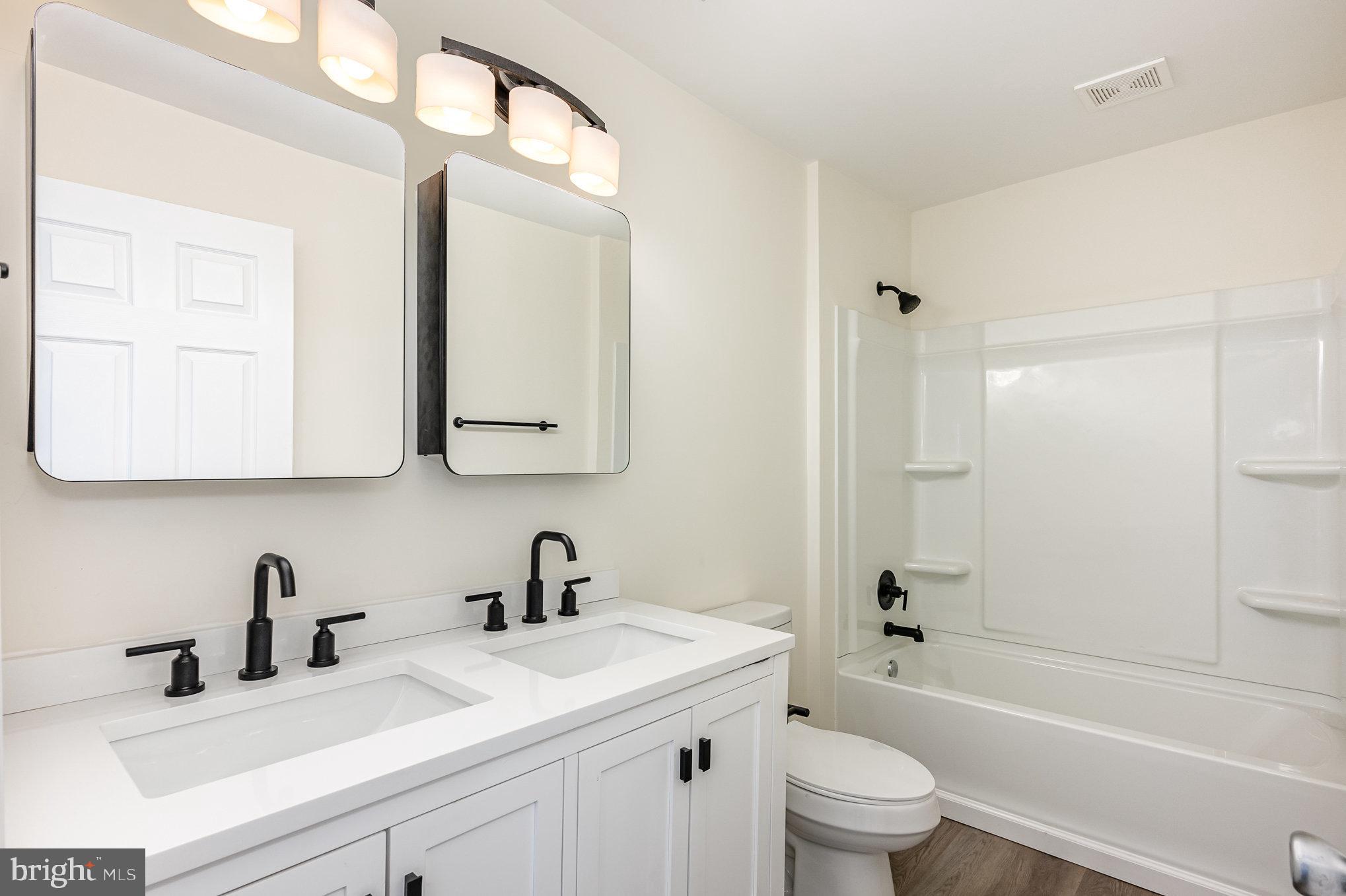 1591 Blue Ball Road Elkton, MD 21921 - Photo 21 of 30 a bathroom with a sink a toilet and a mirror