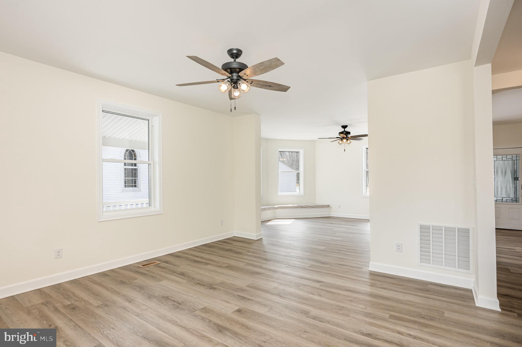 1591 Blue Ball Road Elkton, MD 21921 - Photo 3 of 30 a view of empty room with wooden floor and fan