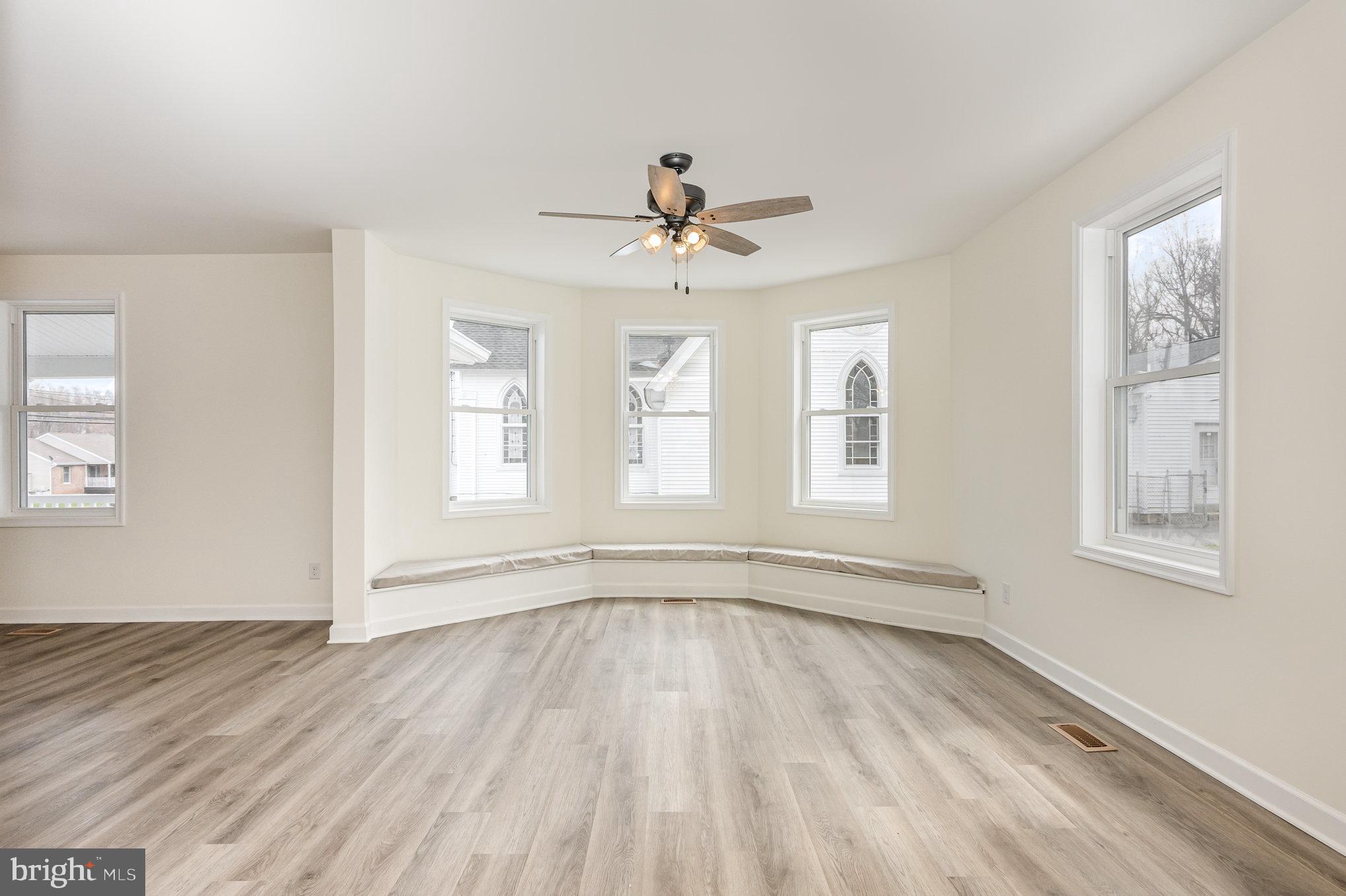 1591 Blue Ball Road Elkton, MD 21921 - Photo 7 of 30 a view of empty room with wooden floor and fan
