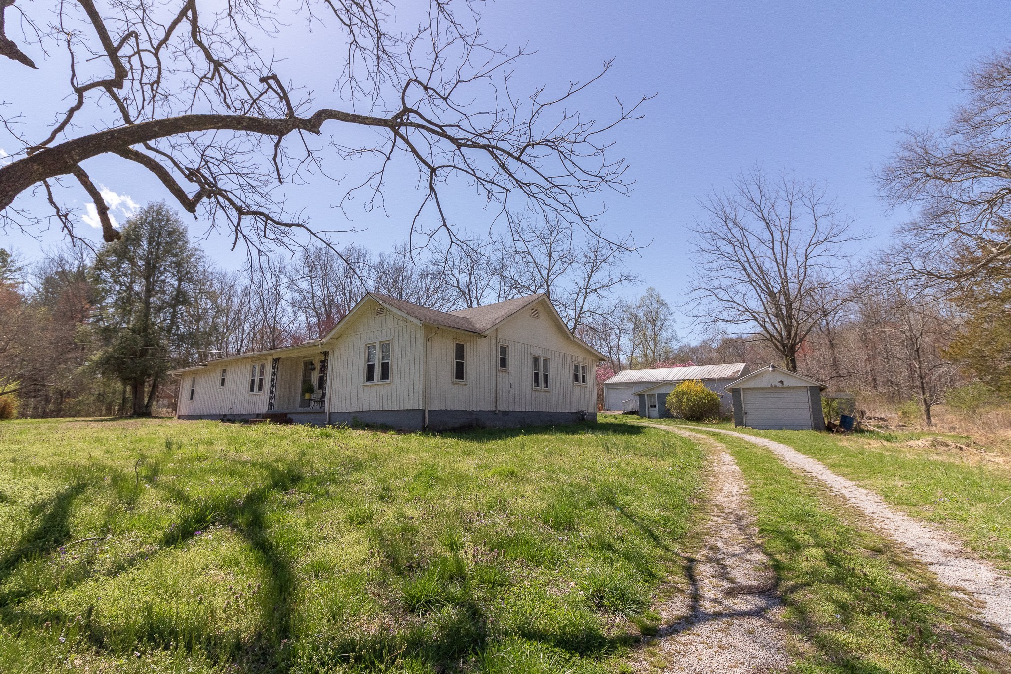 201 South Tunnel Road Portland, TN 37148 - Photo 3 of 41 a white house that has a tree in front of it