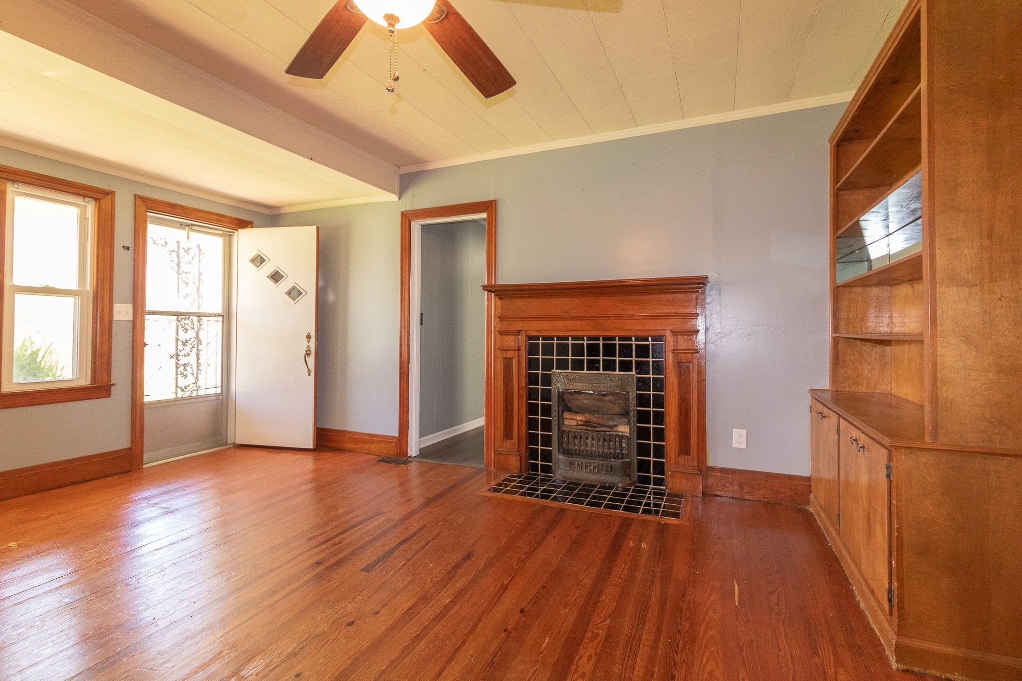201 South Tunnel Road Portland, TN 37148 - Photo 9 of 41 an empty room with wooden floor a fireplace and windows