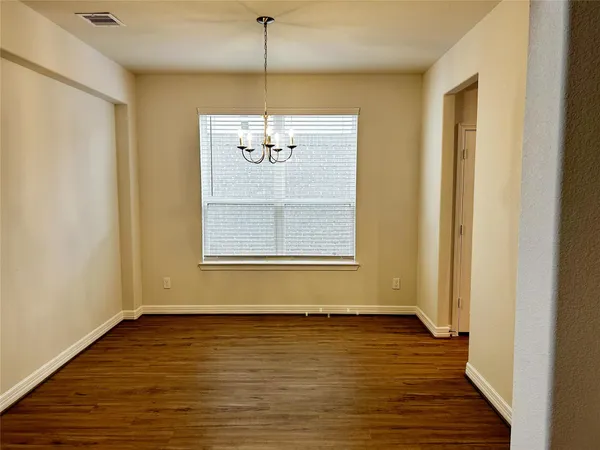 a view of a room with an empty space and a window