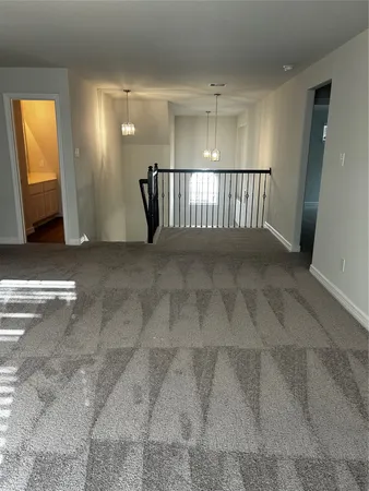 a utility room with wooden floor washer and dryer