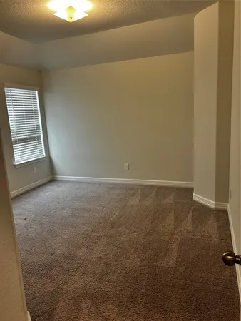 a bathroom with a granite countertop bathtub shower and toilet