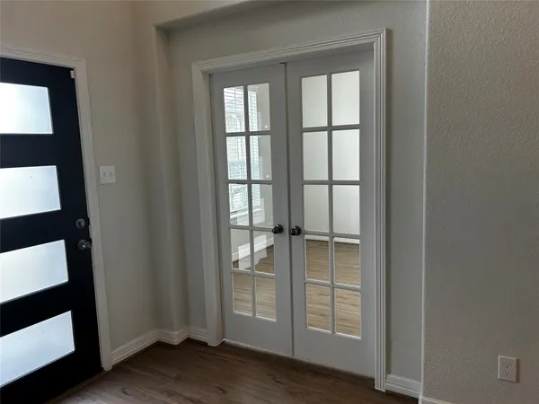 a kitchen with stove cabinets and wooden floor