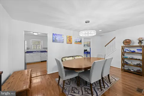 a kitchen with stainless steel appliances granite countertop a kitchen island a stove a table and chairs in it