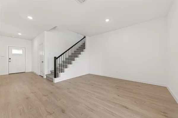a view of entryway and hall with wooden floor