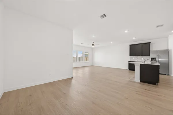 a view of kitchen with microwave oven stove and cabinets
