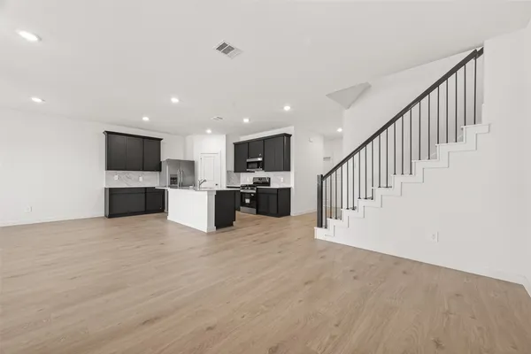a view of a kitchen with a sink and a fireplace in a room