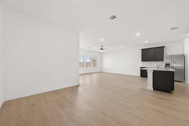 a view of a kitchen with a sink and a fireplace in a room