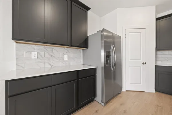 a kitchen with stainless steel appliances a refrigerator and cabinets