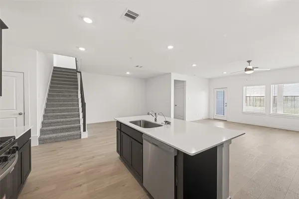 a kitchen with a sink and cabinets