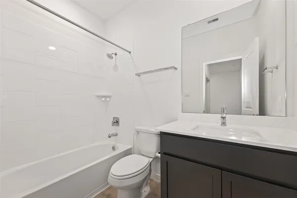 a bathroom with a sink toilet vanity and shower