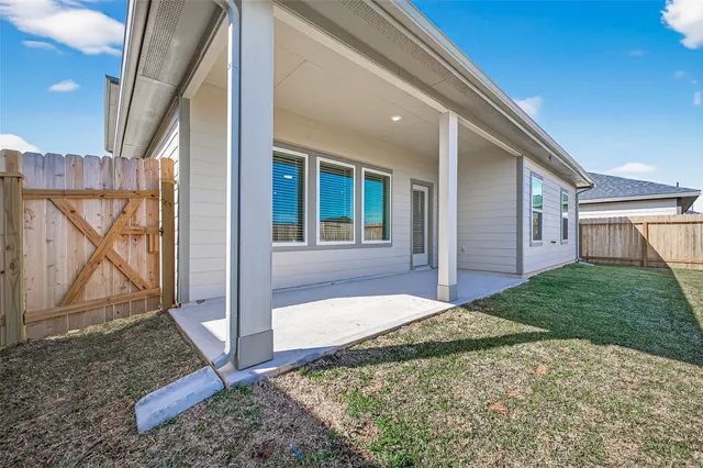 a view of a house with a backyard and a yard