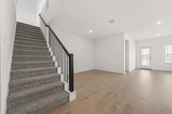 a view of entryway and hall with wooden floor