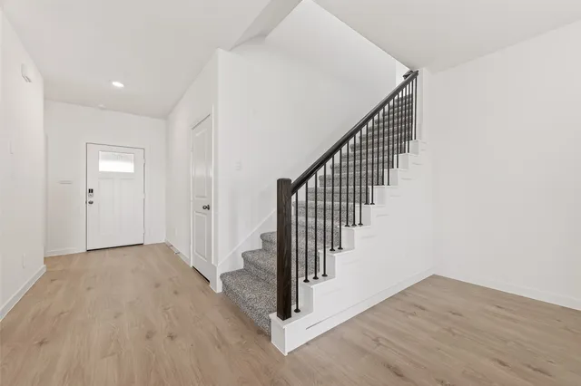 a view of entryway and hall with wooden floor