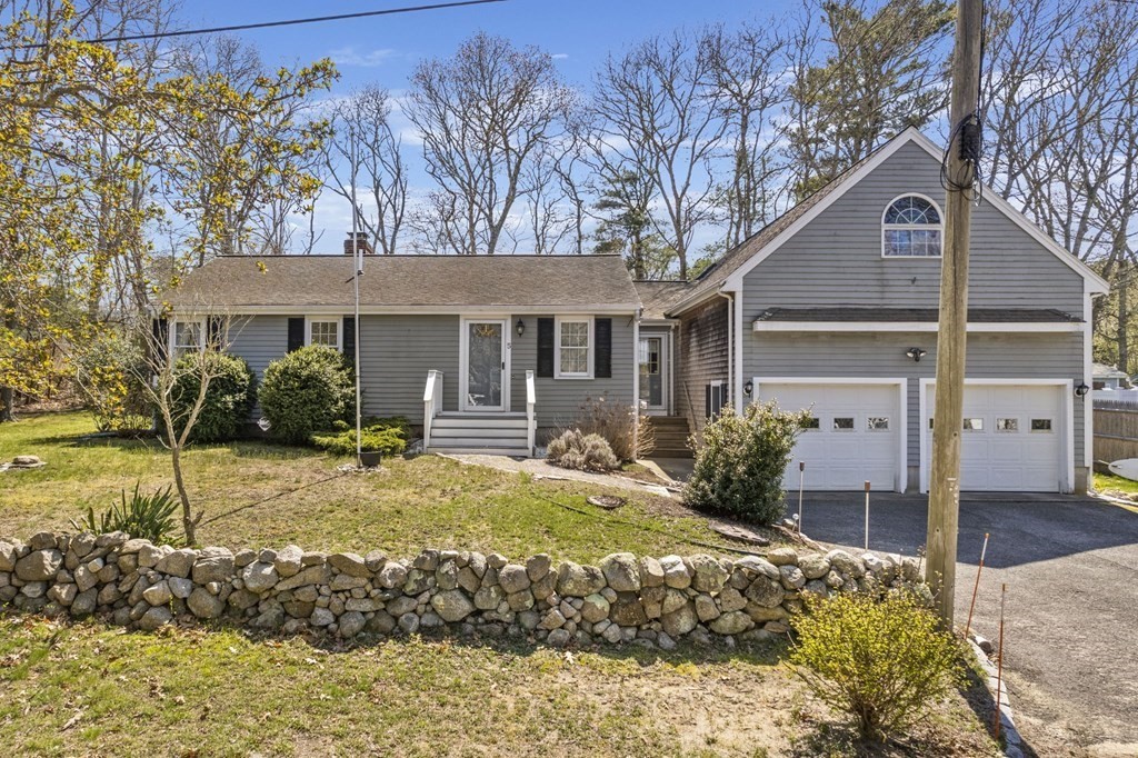 a view of a house with a yard covered in snow