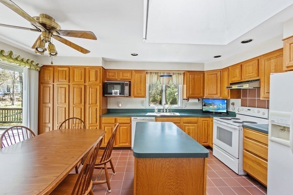 5 Bowler Road Wareham, MA 02571 - Photo 13 of 41 a kitchen with stainless steel appliances granite countertop a stove a sink dishwasher and a refrigerator with wooden floor