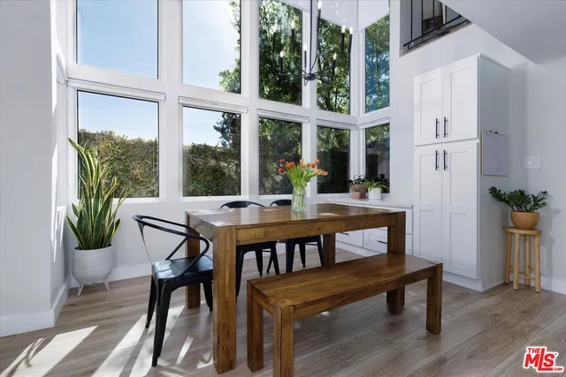 a dining room with furniture window and wooden floor
