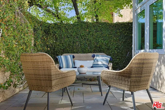 a view of a chairs and table in the balcony