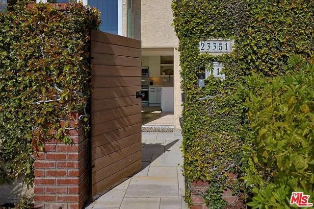 a pathway of a house with a yard