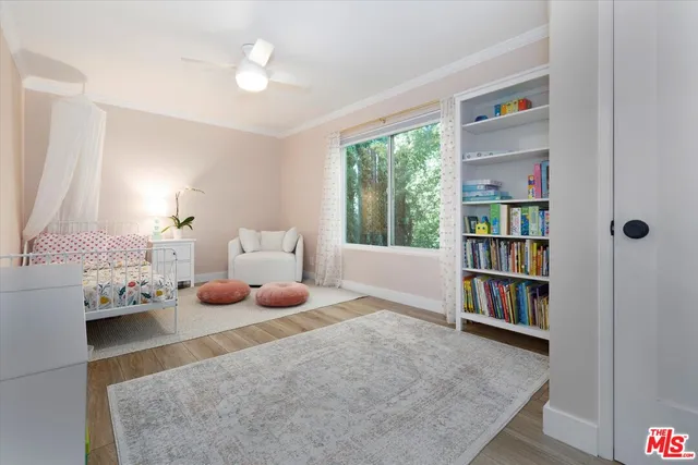 a bedroom with furniture and a book shelf