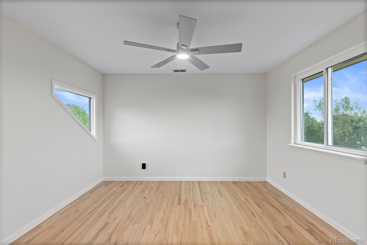 3900 Pierson Street Wheat Ridge, CO 80033 - Photo 31 of 39 wooden floor in an empty room with a window