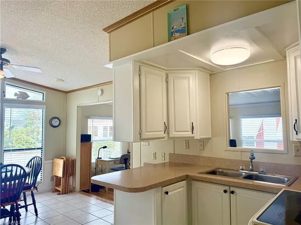 a kitchen with a sink cabinets and window